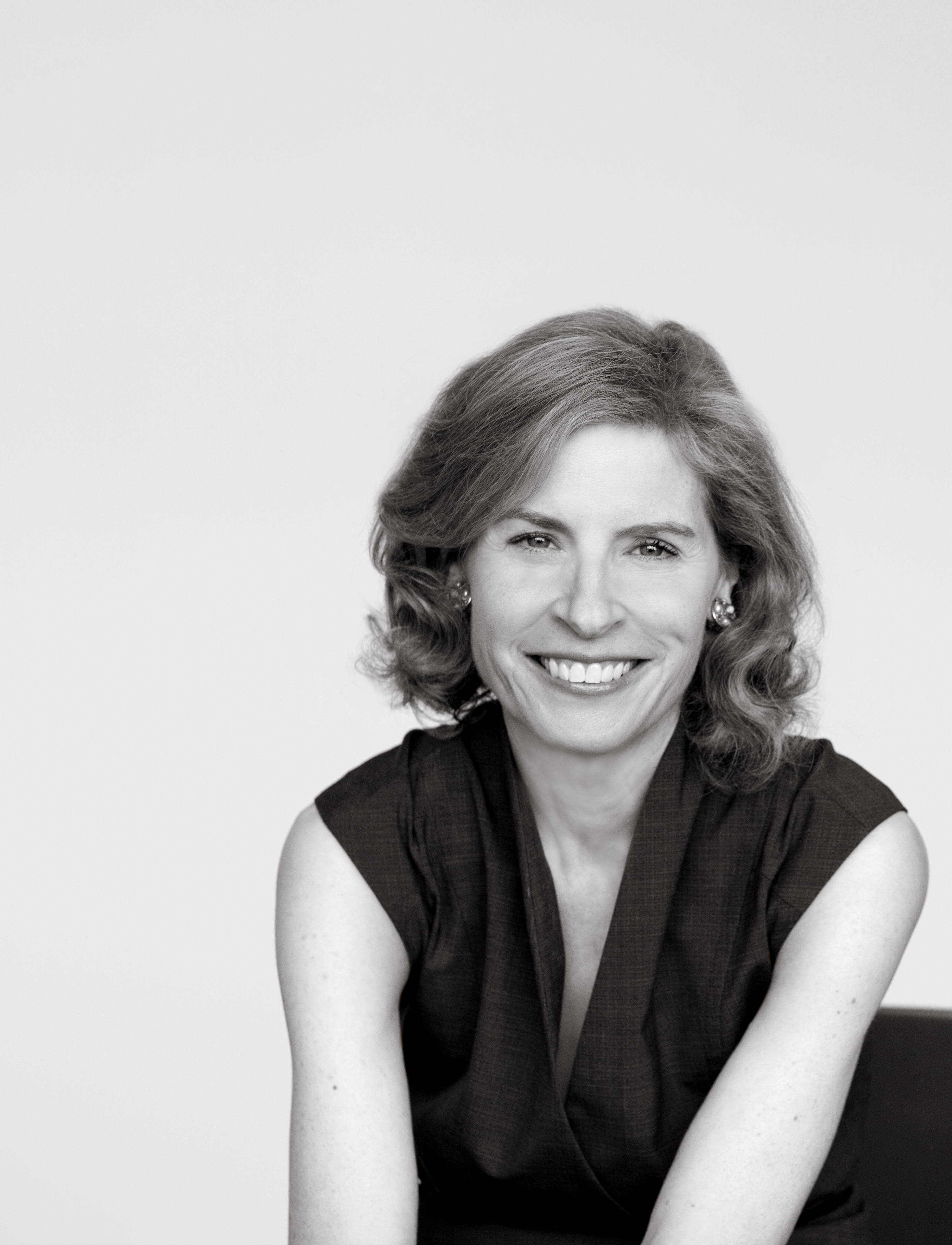 black and white photo of a smiling woman with wavy hair