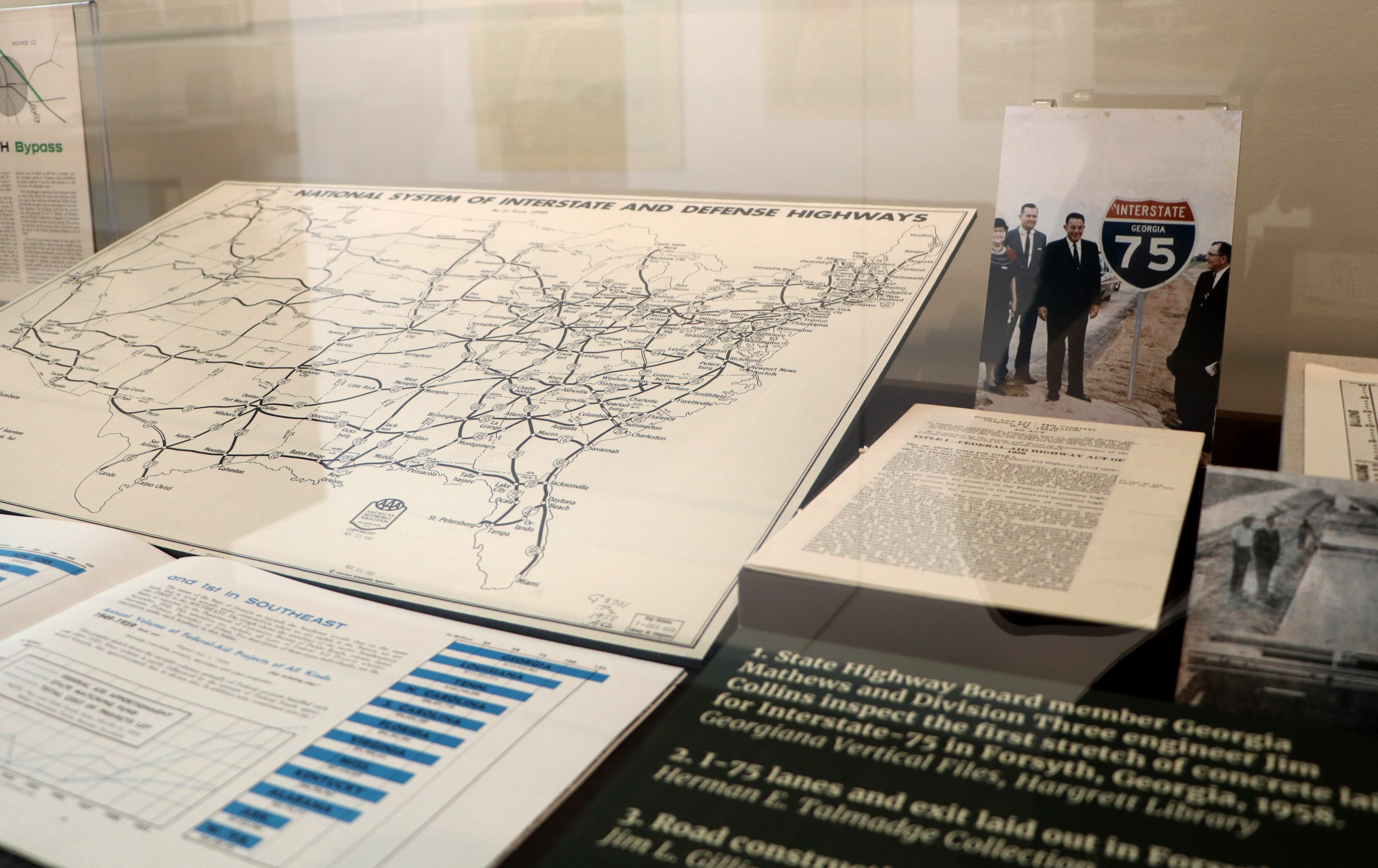 Exhibit case with map and photo of men by interstate sign
