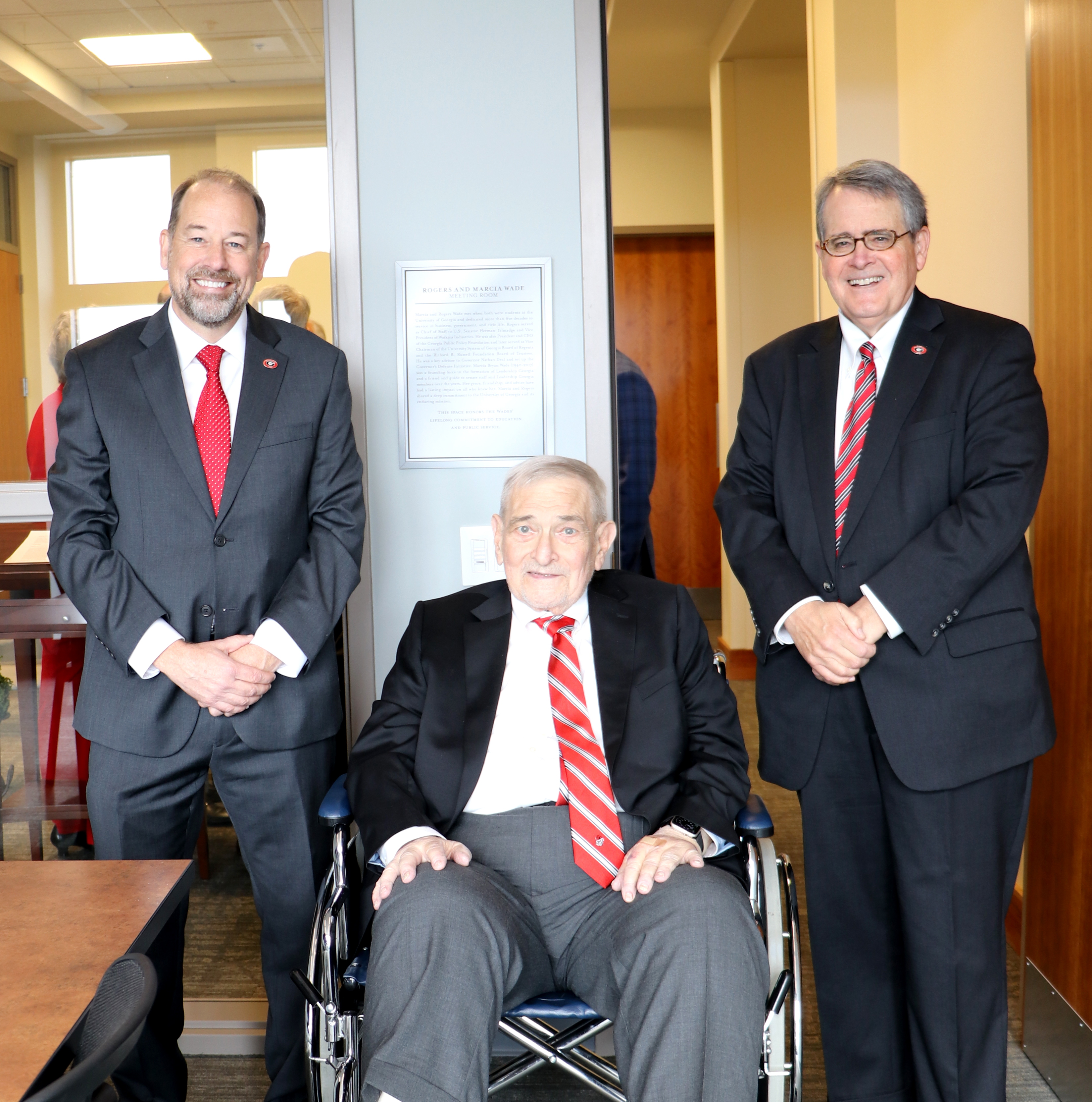 University Librarian Toby Graham (left) and UGA President Jere W. Morehead (right) pose with T. Rogers Wade in front of a plaque commemorating the naming of the Rogers and Marcia Wade Meeting Room at the Richard B. Russell Building Special Collections Libraries.