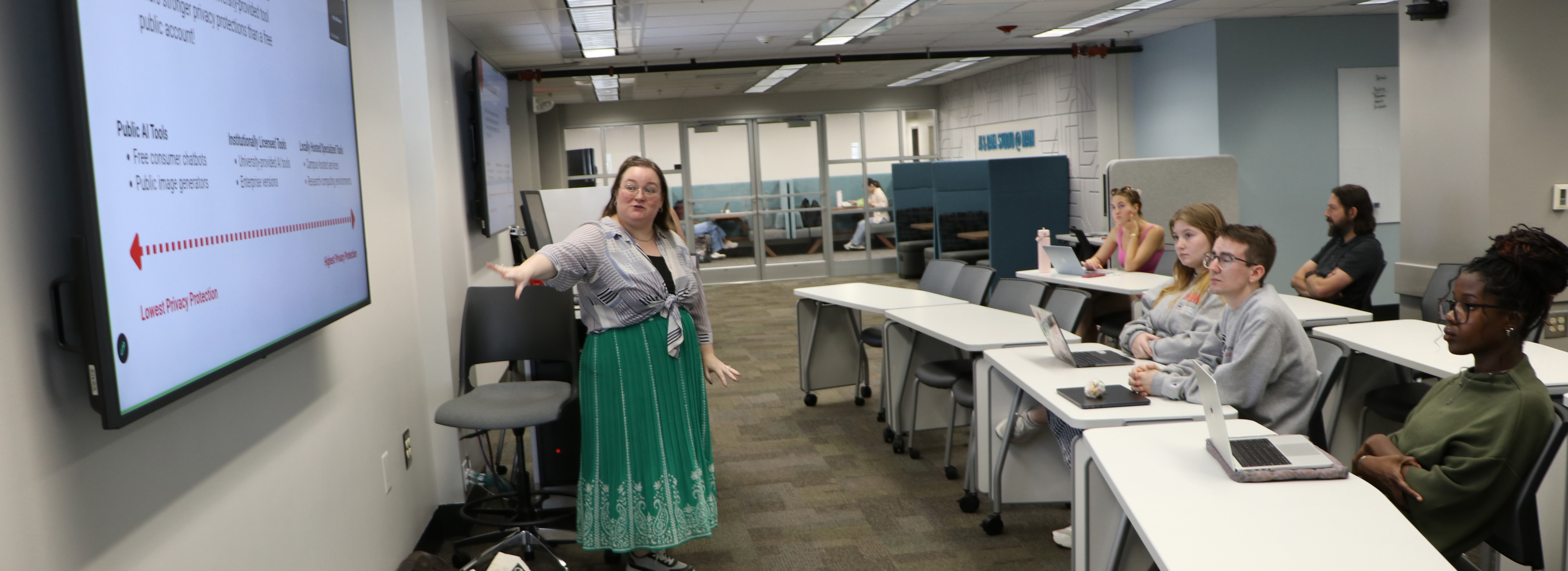 Librarian points to an AI presentation at the AI & Data Studio at the UGA Main Library