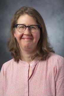 Woman with shoulder length hair wearing glasses