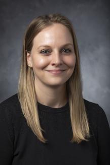 Woman with long blond hair wearing a black shirt.