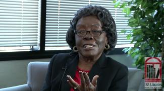Gussie Phillips, a middle-aged African-American woman, gestures as she talks in her oral history interview