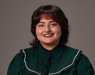 Woman with green top and bangs smiling