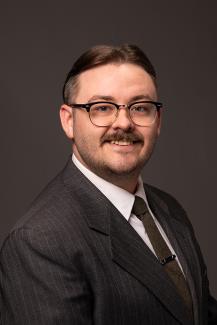 Man with glasses, moustache, and a tie