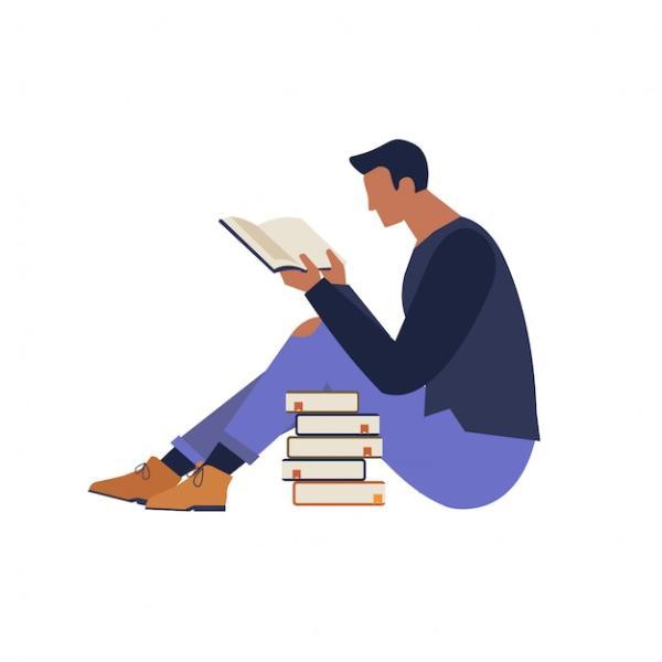Man reading a book sitting next to a stack of books