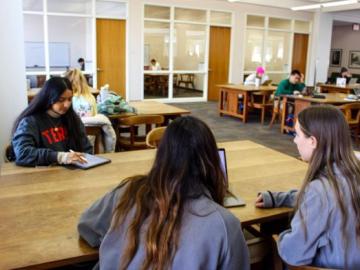 3 UGA students sitting together at a study table in the MLC>